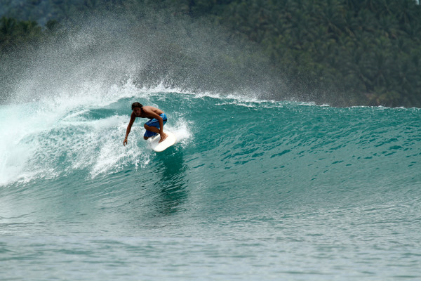 Speed surfer on tropical green wave