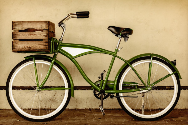 Retro styled sepia image of a vintage bicycle with wooden crate