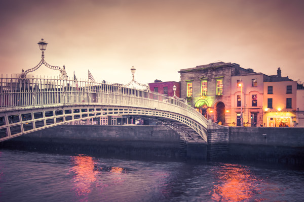 Vintage style historic Ha’penny Bridge, Dublin Ireland at dusk