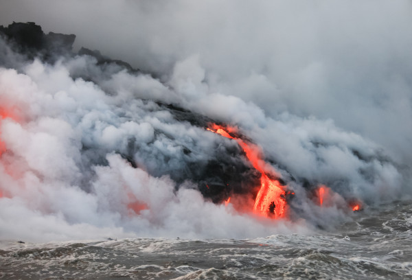 Red hot lava flowing into Pacific Ocean on Big Island, Hawaii