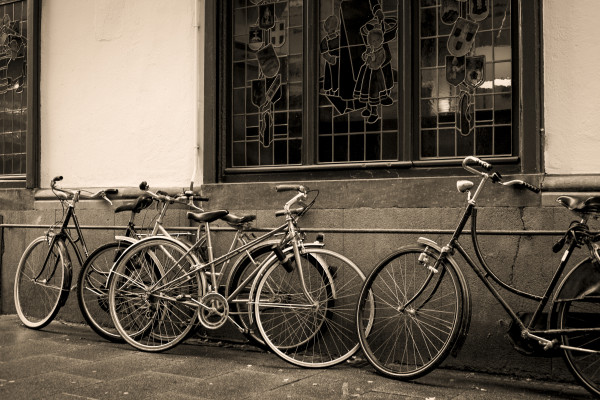 Bicycles leaning against old wall in sepia