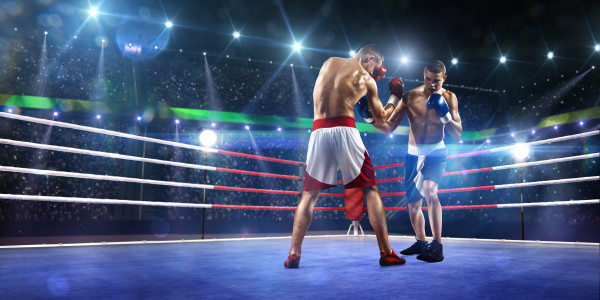 Two professionl boxers are fighting on arena