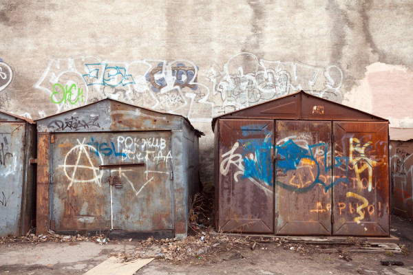 Old rusted locked garages with grungy graffiti