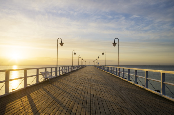 The wooden pier on the sea at sunrise