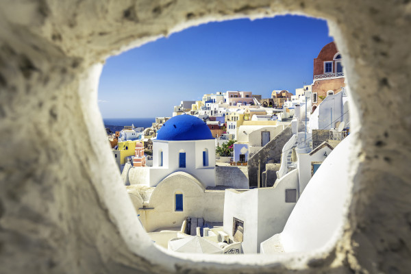 Santorini blue dome church look through the chimney, Greece