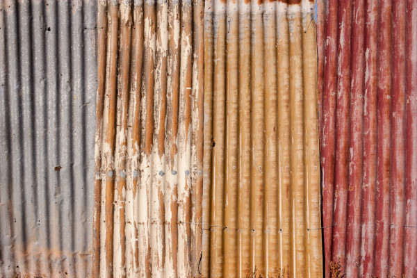 Grunge background of weathered corrugated iron fence