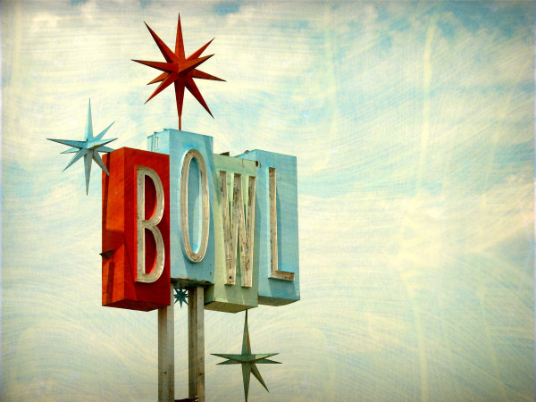 aged and worn vintage photo of neon bowl sign