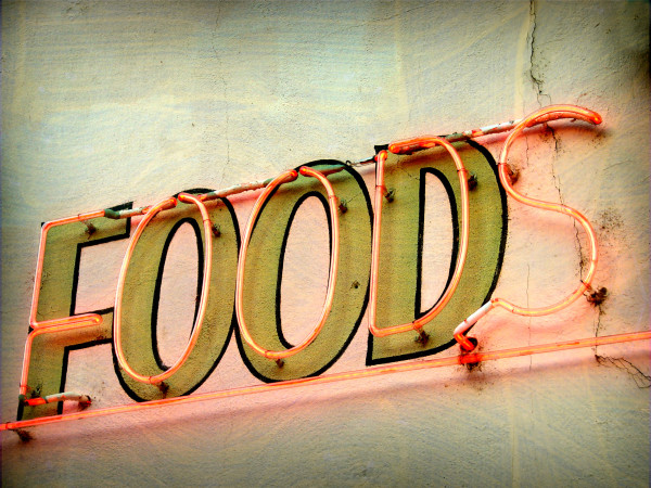 aged and worn vintage photo of neon food sign