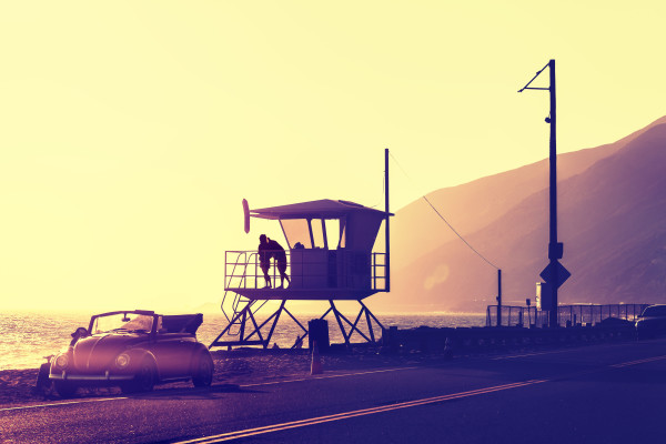 Vintage filtered sunset over beach with lifeguard tower, Pacific