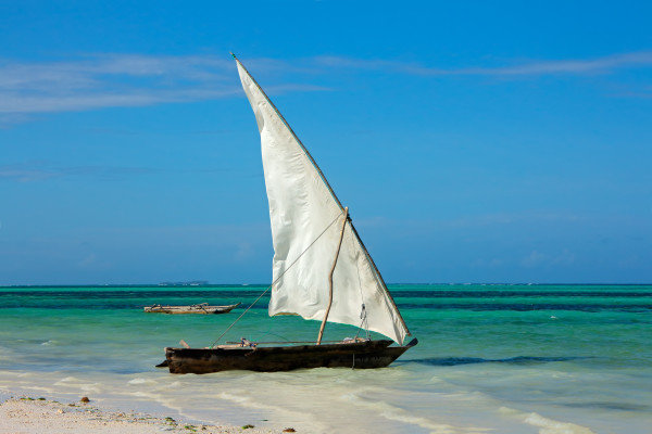 Wooden sailboat (dhow) on a tropical beach of Zanzibar island.