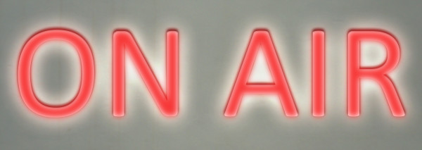 Neon “on air” sign indicating a  broadcasting program in progress