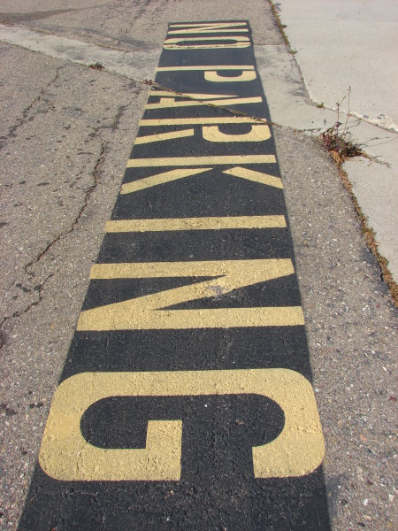 No parking sign on pavement