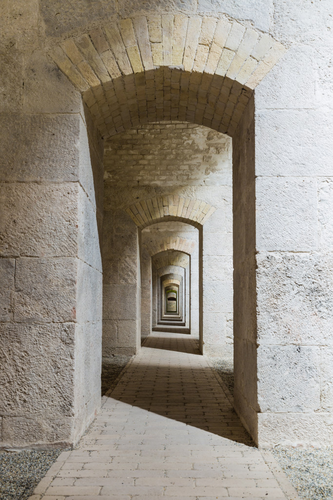 Castle tunnel interior with a series of symmetric arches in a bastion fortress.