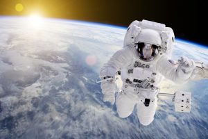 Astronaut in Space, in background our earth an the sun   Elements of this image furnished by NASA