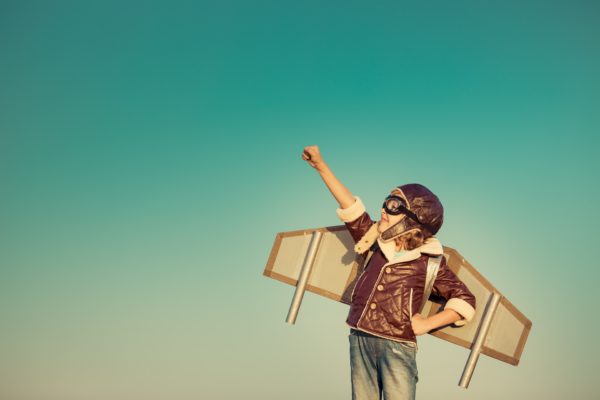 Happy child playing with toy airplane