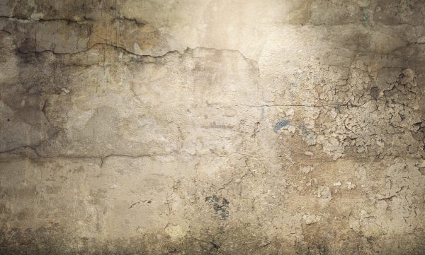 Dark empty room with old damaged concrete wall and ceiling lamp shining. 3d rendering
