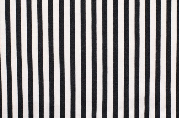 Navy blue and white striped background. Vertical stripes pattern on fabric.